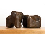 two pieces of wood sitting on top of a wooden table