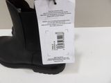 black boots with a price tag on them sitting on a white table