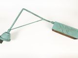 a green light that is attached to a metal pole
