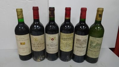 six bottles of wine are lined up in a row on a table
