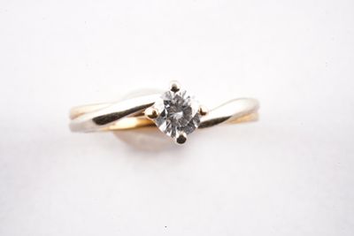 gros plan d'une bague en diamant sur une surface blanche