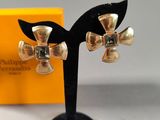 pair of silver bells on a black stand with a yellow box in the background