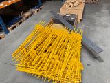 a large pile of yellow poles in a warehouse