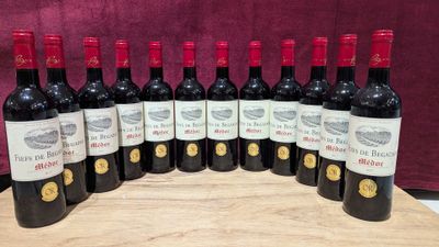 six bottles of red wine are lined up on a wooden board