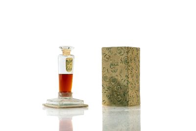 a small bottle with a liquid inside of it next to a small box