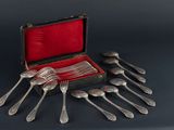 a bunch of silver spoons and forks in a case
