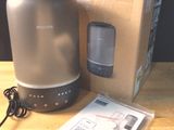 a box with a speaker and a charger on a table