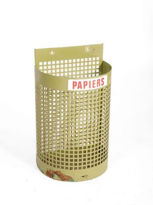 a green trash can with a paper sign on it