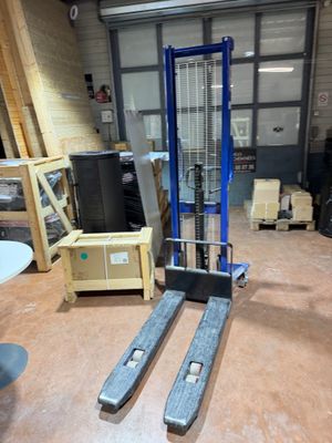 a fork lift in the middle of a warehouse floor