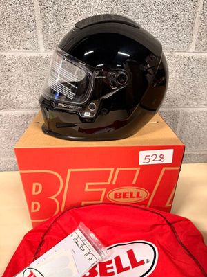 a helmet and a bag on a table next to a brick wall