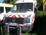 several ambulances parked in a grassy field with trees in the background