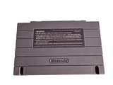 a close up of a nintendo game system on a white surface
