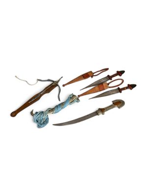 many different types of knives on a white surface