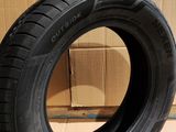someone uses a pair of scissors to cut a tire on a cardboard box