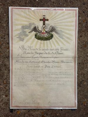 an old document with a cross on it sitting on the ground