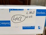 a box with a sticker on it sitting on the floor