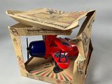 a small toy airplane in a cardboard box on a table