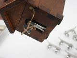 a small wooden box with a bunch of keys in it