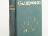 an old green book with gold lettering on a white background
