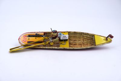 a small boat that is sitting on a white surface