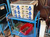a blue cart with a bunch of electronic equipment on it