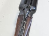 a close up of a rifle on a table with a white background