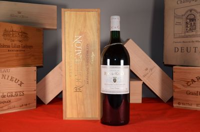 a bottle of wine sitting on a table next to wooden boxes