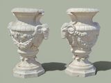 two white vases sitting next to each other on a table