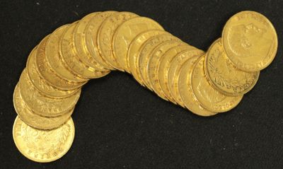 a pile of gold coins sitting on a black surface