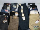 several pairs of men ' s jeans are lined up on a white surface