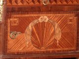 an image of a wooden chest of drawers with a clock on top of it