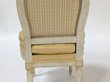 a small chair with a seat made of wood and wicker