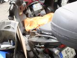 many motor scooters parked on the side of the street
