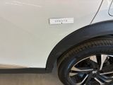 a small white car with a sticker on the side of it