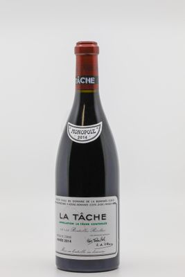 une bouteille de vin posée sur une table blanche