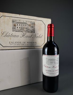 a bottle of wine that is sitting next to a box