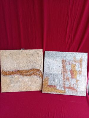 two pieces of art on a red cloth with a red background