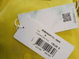a close up of a yellow jacket with a tag on it
