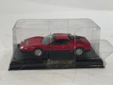 a red car in a glass case on a black base