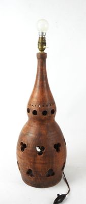 a wooden lamp that is sitting on a table