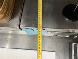 a measuring tape that is on the side of a stove