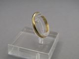 an image of a gold wedding ring on a clear acrylic stand