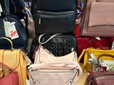 a lot of purses on the table in the store