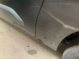 a close up of a car with a denting on the side