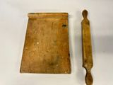 a wooden board with a wooden handle next to it