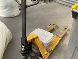 a man standing next to a pallet with a bag on it