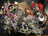 a black table with a bunch of jewelry on it
