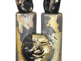 pair of bronze sculptures of hands holding a ball on top of each other