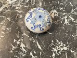 a dog that is laying on the floor next to a ball
