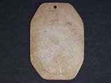 a close up of a wooden cutting board on a black surface